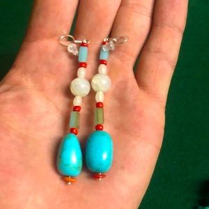 Turquoise, Tourmaline, quartz, coral set in silver.